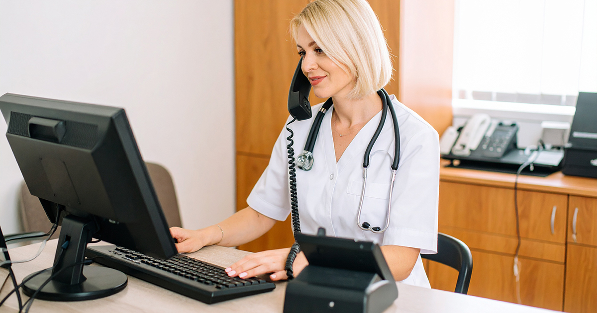 photo of a uniformed nurse talking on the telephone
